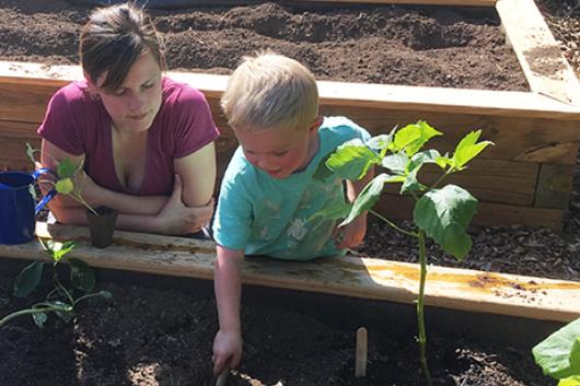 Parent and child gardening together